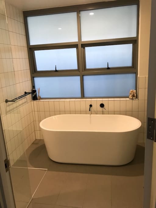 bathroom with separate bath and shower
