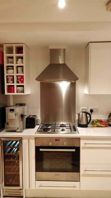 Kitchen with gas stove and bean to cup espresso machine