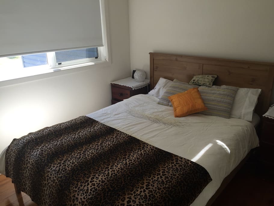 Bedroom 1 with queen bed faces escarpment and permanent temperate creek across the road.