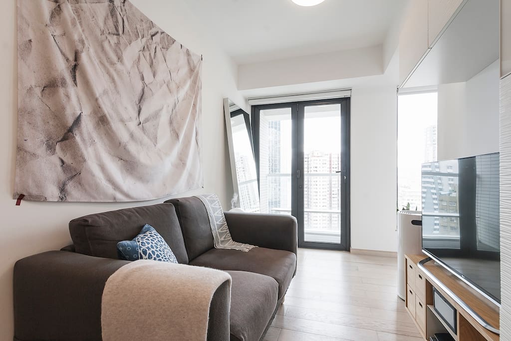 Bright living room with sitting area and TV