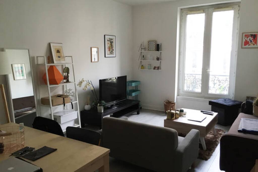 Living room with two sofas, TV, low table, dinner table