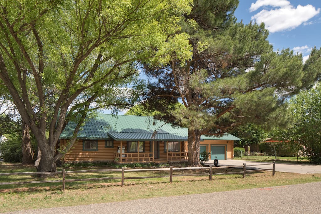 Front of the house with two large shade trees
