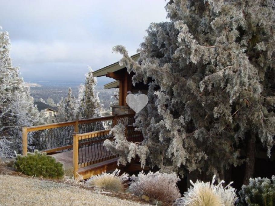 On the side of Awbrey Butte, the front of the home is sweetly hidden by local Juniper trees.