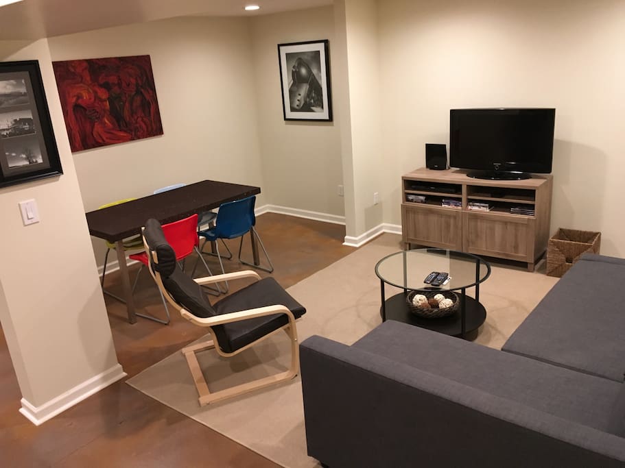 Spacious living room area with dining table. Lots of light.