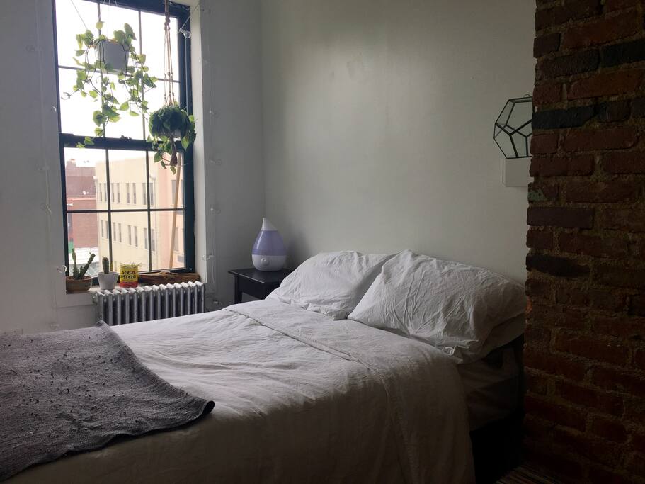 Bedroom w/ full bed. Humidifier bedside and lovely plants.