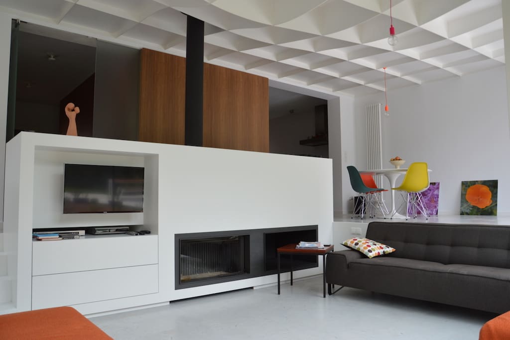 Living room with fire place & all-steel ceiling.