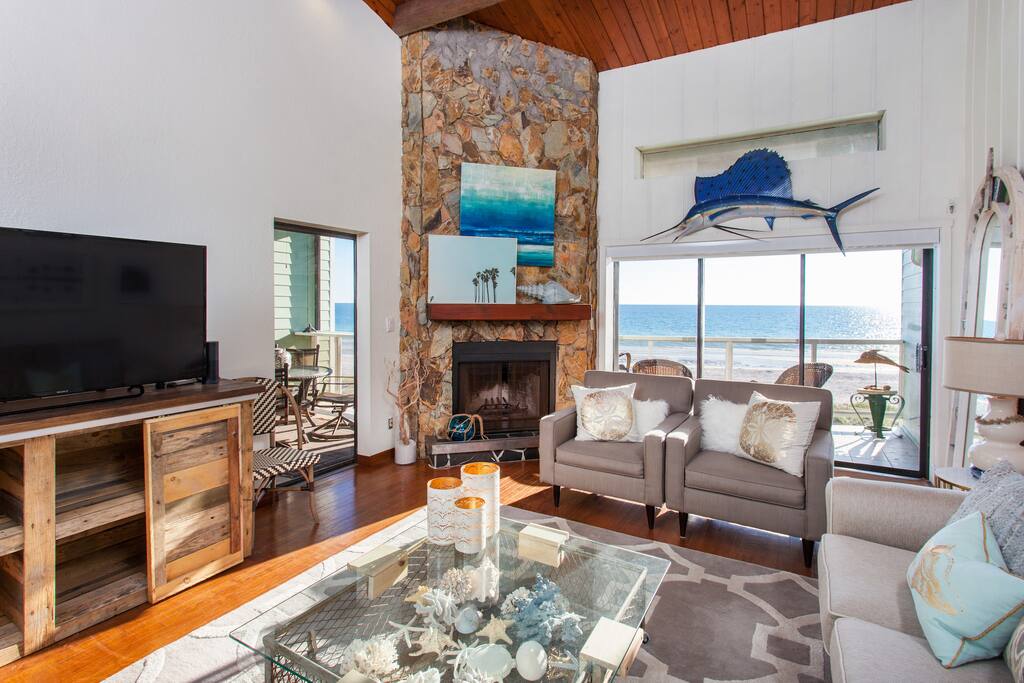 Vintage beach meets modern chic in our large family room with 2 private balconies, 18' ceilings and 55" flat screen