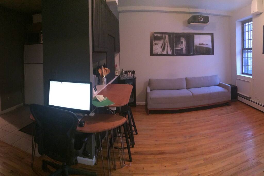 wide view from bedroom door: of living room/kitchen/bathroom