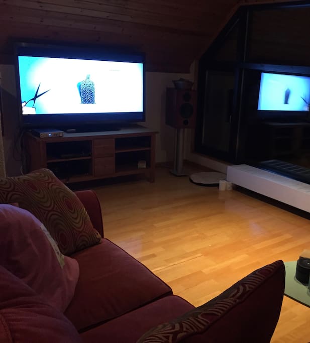 Family room on the upper floor, with panoramic window over the garden
