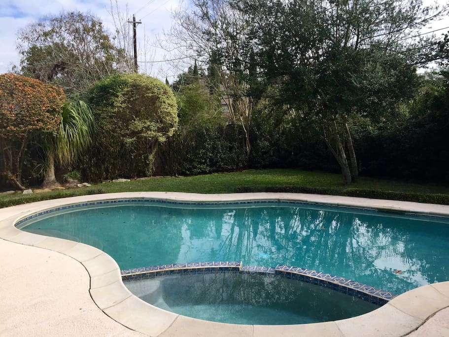 Heated pool and hot tub in nicely landscaped backyard with privacy fence.
