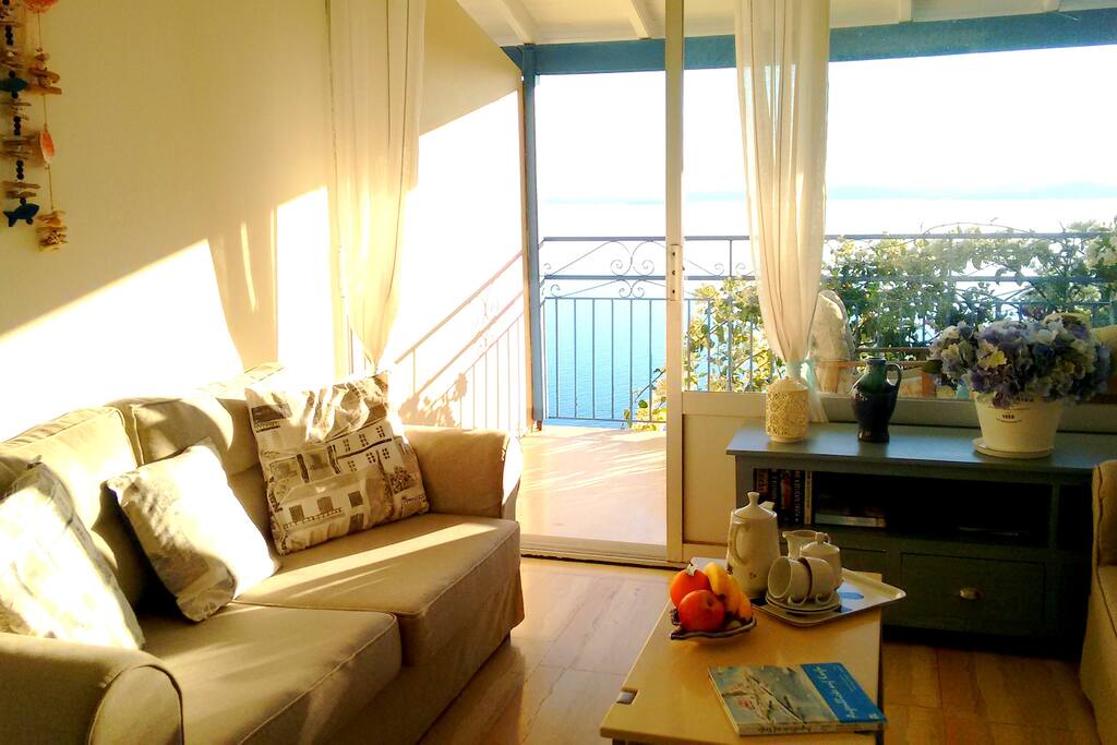 Living room with doors onto the sunny balcony.