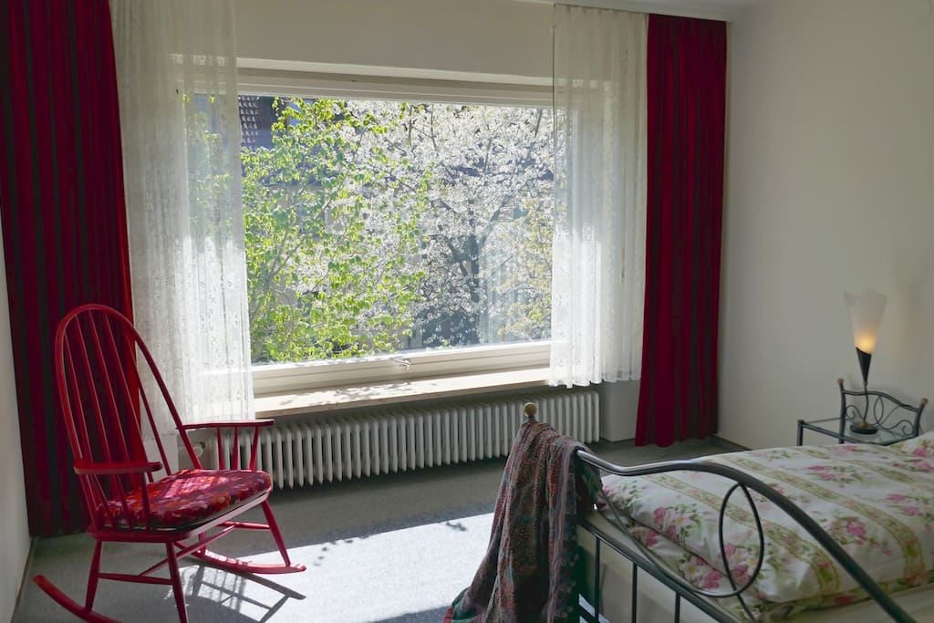 Red velvet curtains frame the huge window in the "red room". I have other bedlinen as well, if ruffles are not your style.