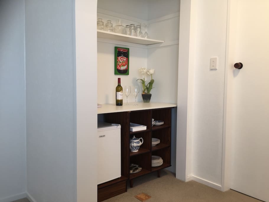 Kitchen area, bar fridge, toaster, hot water jug (kettle), china, glasses (wine & water), coffee plunger & tea pot, cutlery etc