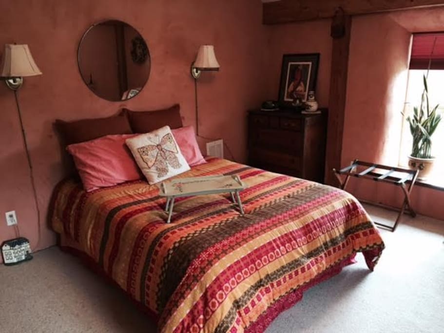 Large room with great countryside views, closet, dresser, and dressing table. All draped in warm adobe colors.
