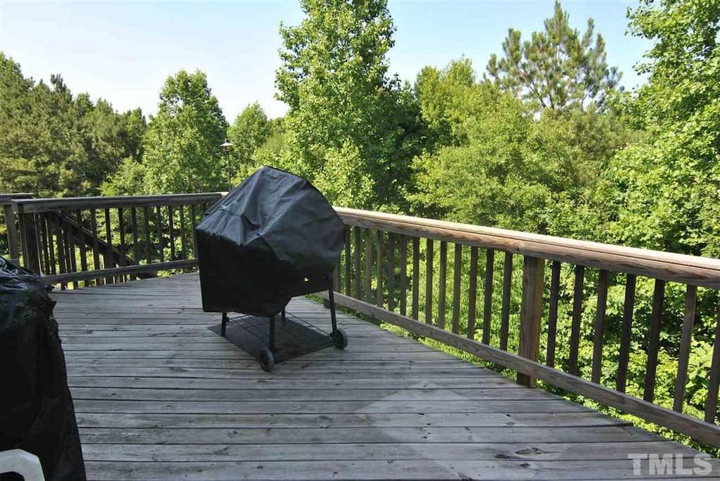 Spacious Back Deck for Relaxing and enjoying a wooded view.