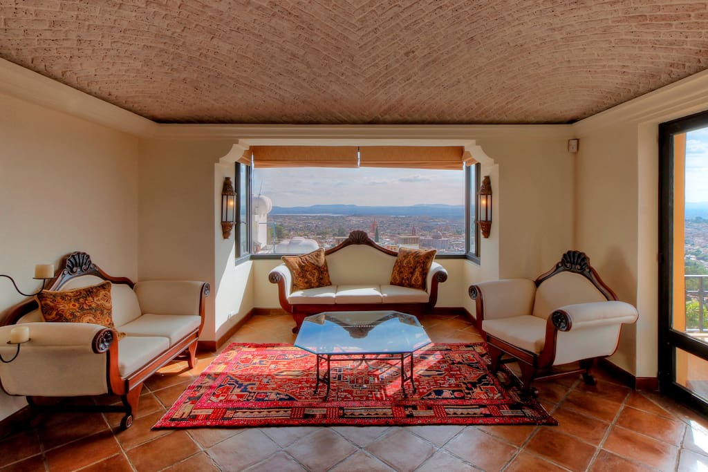 Persian rugs, a bay window and a stunning view of the Paroquia add to the glamor of this 32 foot room.
