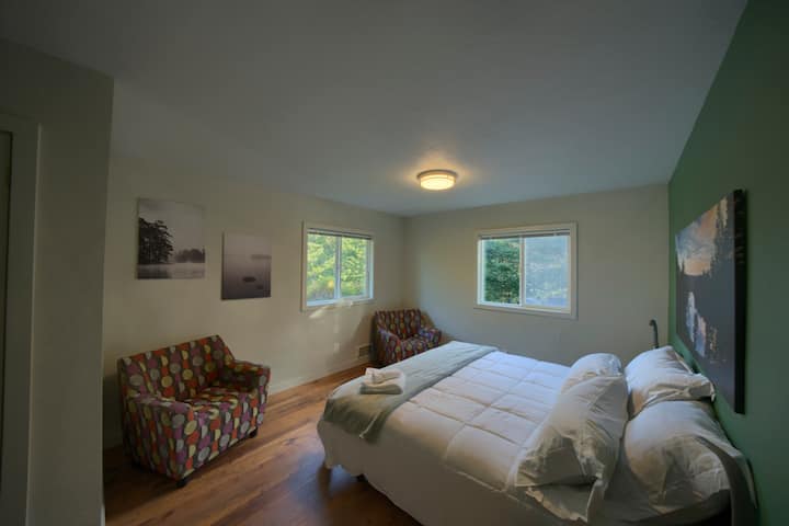 Master bedroom with cozy Herman Miller chairs