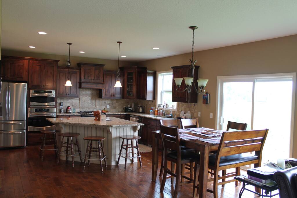 Full kitchen with refrigerator, freezer, microwave, two ovens, stove, dishwasher, and seating for ten.