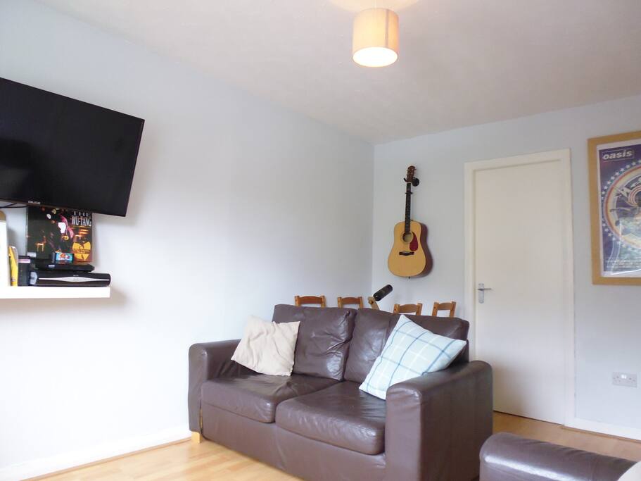 Living area with television, wifi, dining table and sofa bed