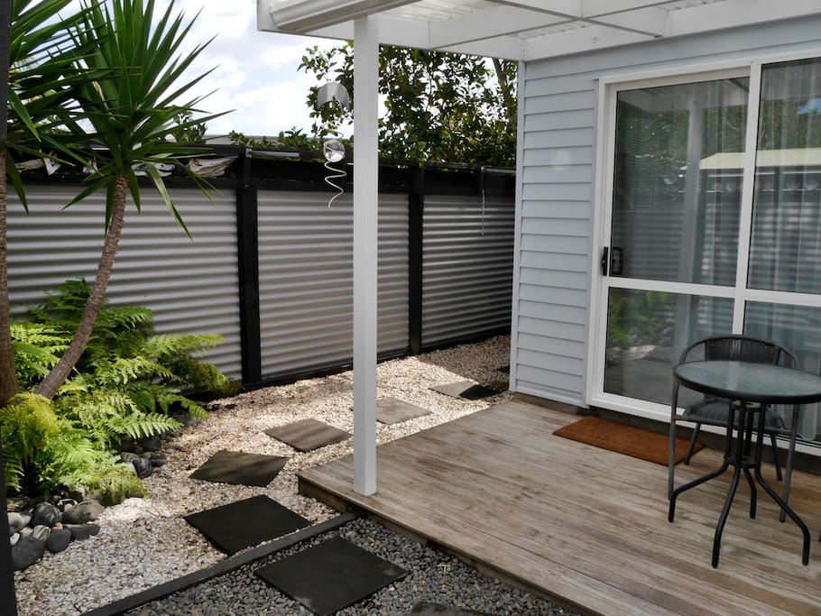 Outside deck and garden with table and chairs.