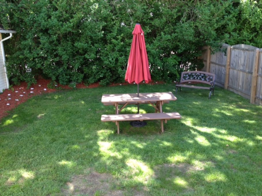 Private backyard with gas grill and enclosed outdoor shower.