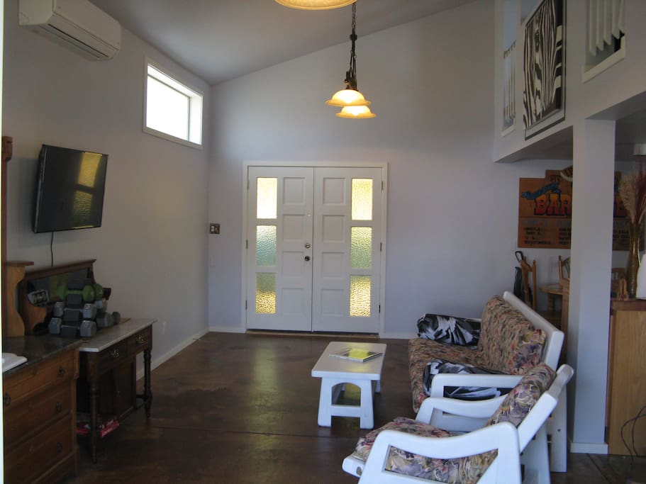 View from entry door to double door entry, TV & futon set