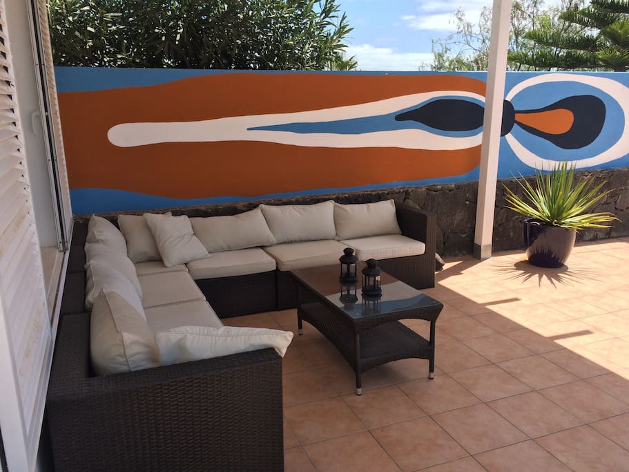 Sit outside in the shade while watching The sea and Fuerteventura island