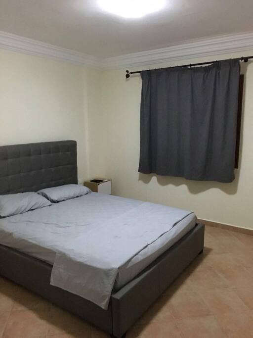 Master bedroom equipped with a TV, an air conditioner and a bathroom