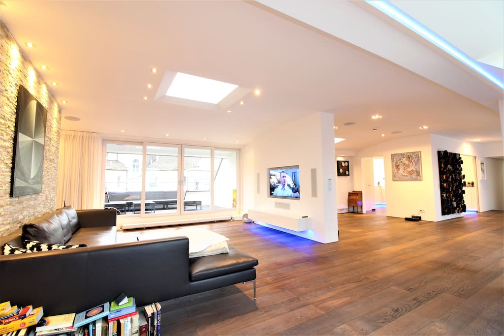 TV area with comfy leather couch; balcony in the back