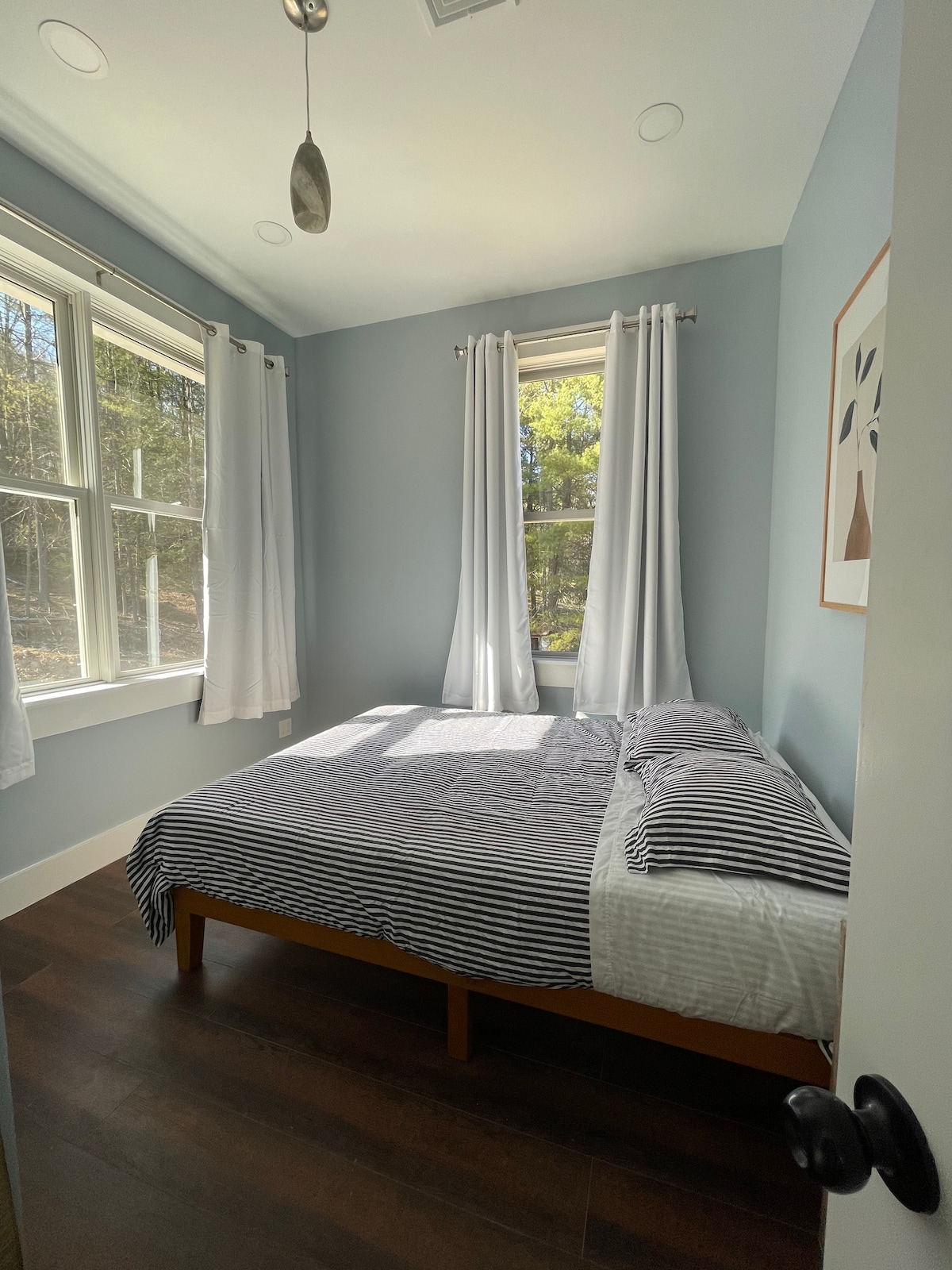 Bedroom #7, queen bed.  Peaceful view of the back yard and woods. 