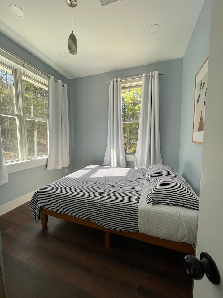 Bedroom #7, queen bed.  Peaceful view of the back yard and woods. 