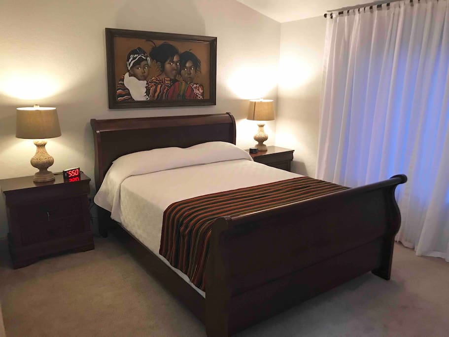 The second bedroom has a queen size bed, two nightstands and a large dresser.
