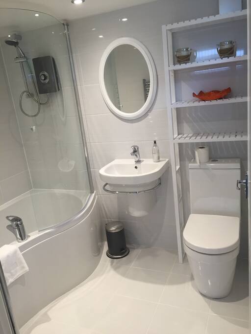 New bathroom with bath and electric shower. Heated towel rail and underfloor heating.