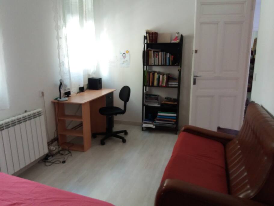 Dormitorio con cama doble y espacio de trabajo