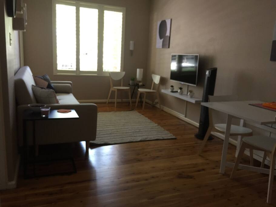 There is lots of sunlight coming into the apartment through the large windows.