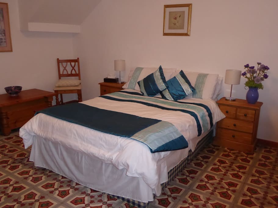 Bedroom 1, double bed. Note tiled floor