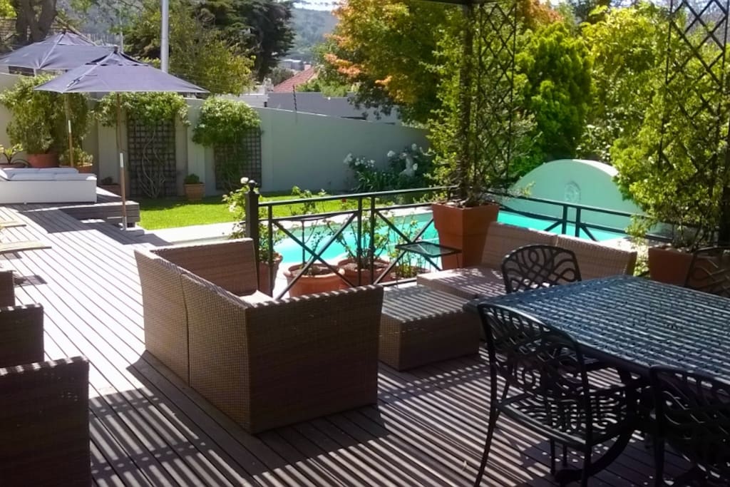 Shaded patio overlooking pool and garden.