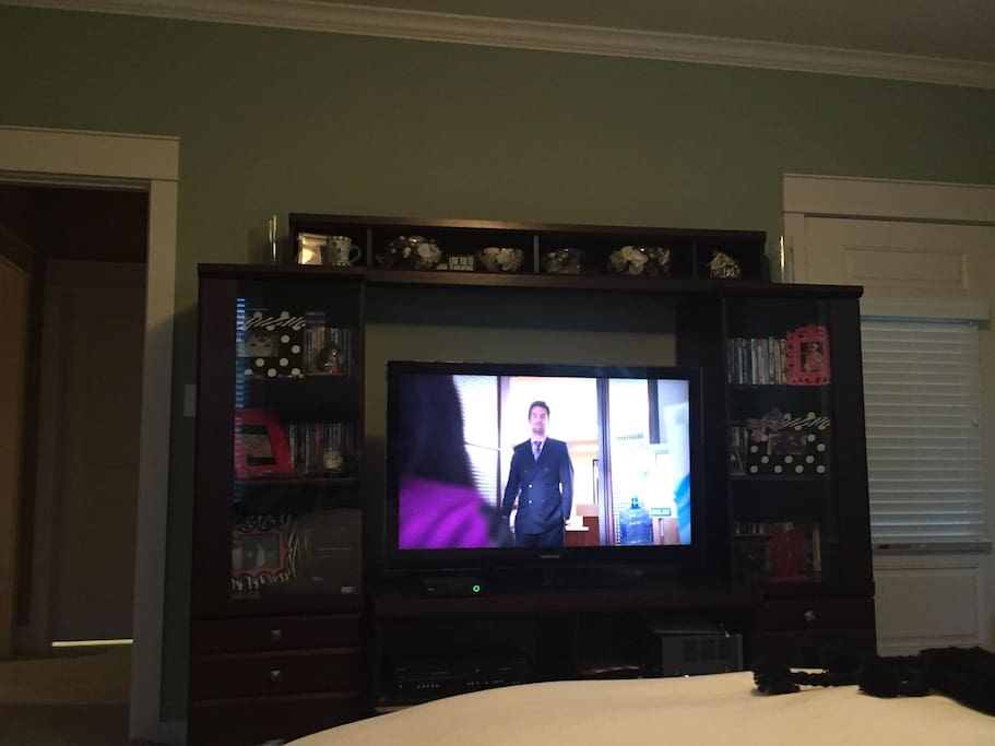 Large decorative entertainment center and TV.