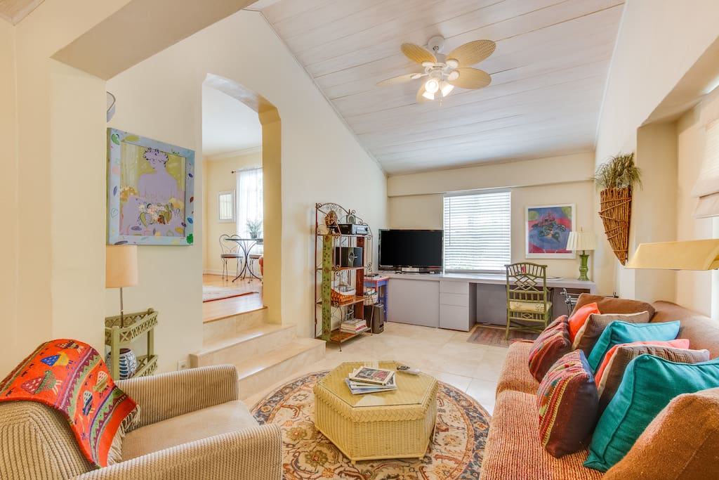 Den with entertainment and work areas. Living room to left