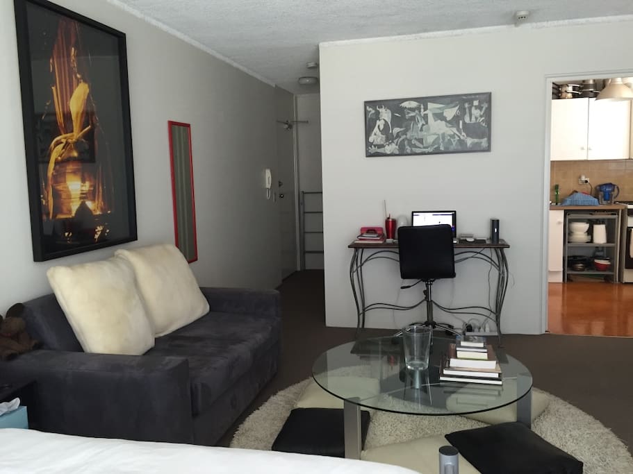 View of lounge, workspace and kitchen.