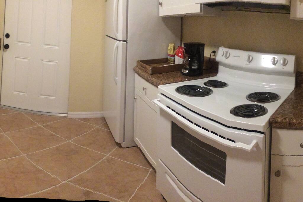 Kitchen with complimentary coffee, serveware, and basic cookware.