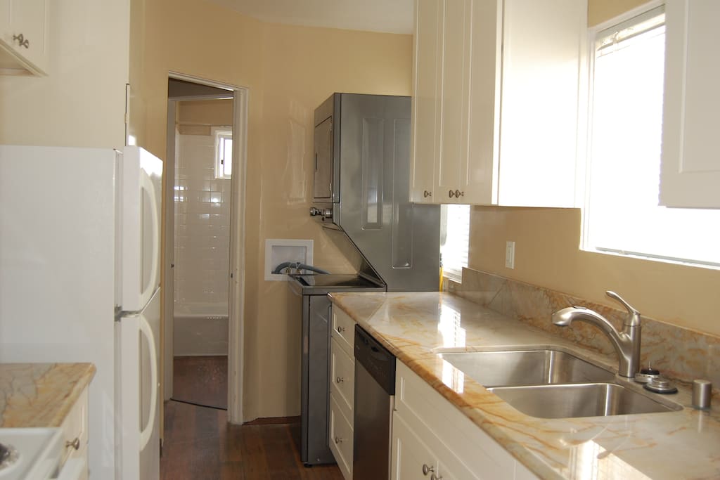 Newly upgraded kitchen with quartz counter tops, dishwasher, washer and dryer