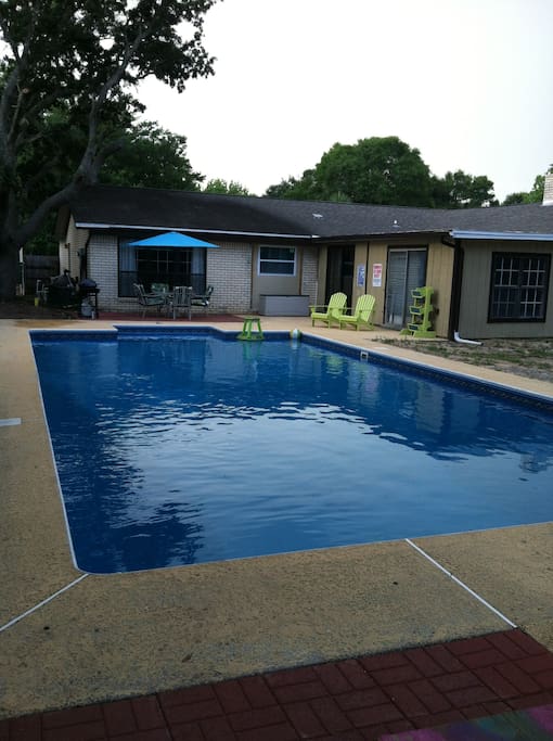 Large Pool with patio table, bbq and relaxing chairs.