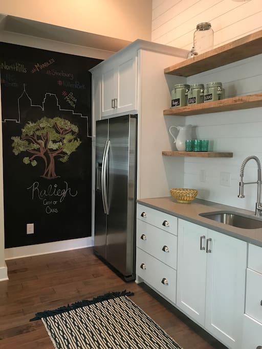 Kitchen space with basic dishware, toaster oven, and full-size fridge and freezer. Complimentary coffee available for all guests.