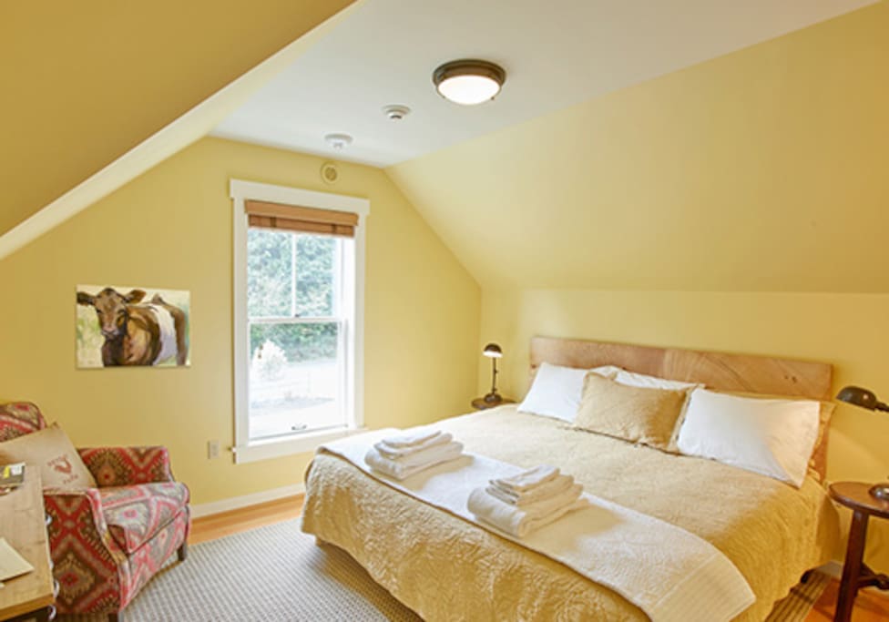 Room 2 has rustic furniture, an in-room wash basin and access to a hallway bath.