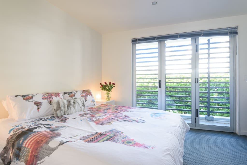 Spacious room with balcony overlooking trees