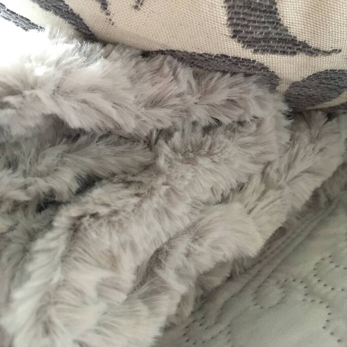 Cosy throws and cushions make a warm welcome