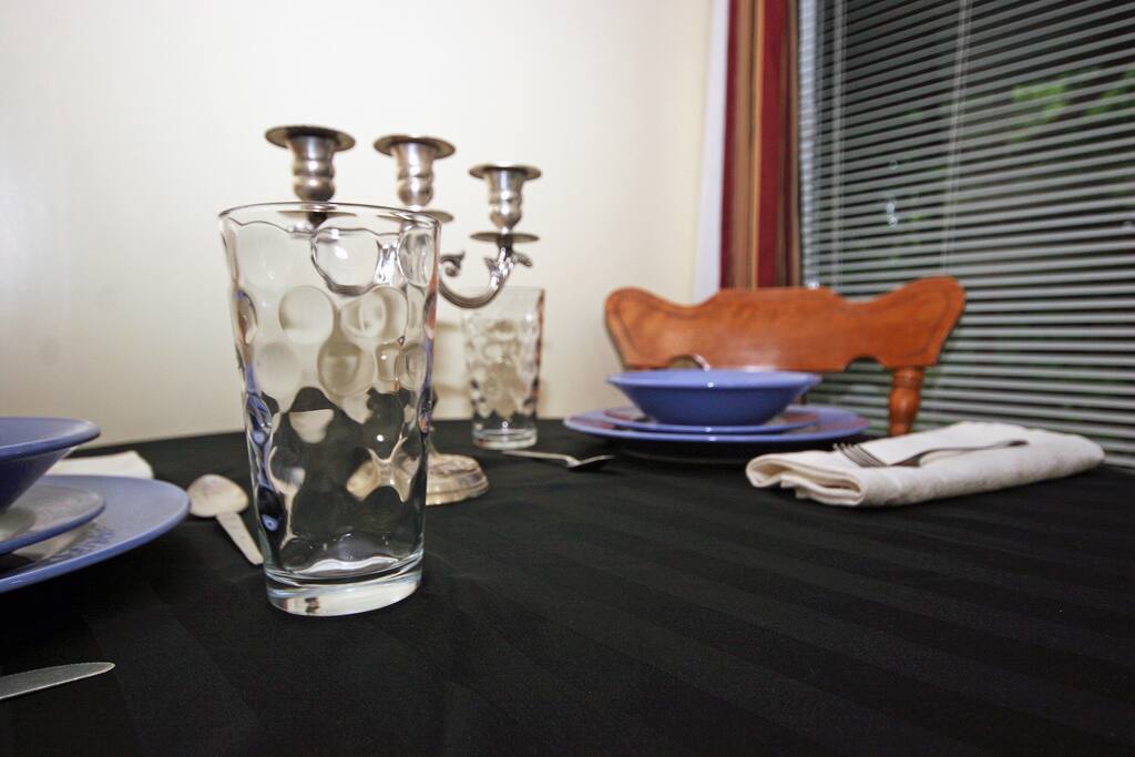 Dining table with patio doors leading to backyard in background