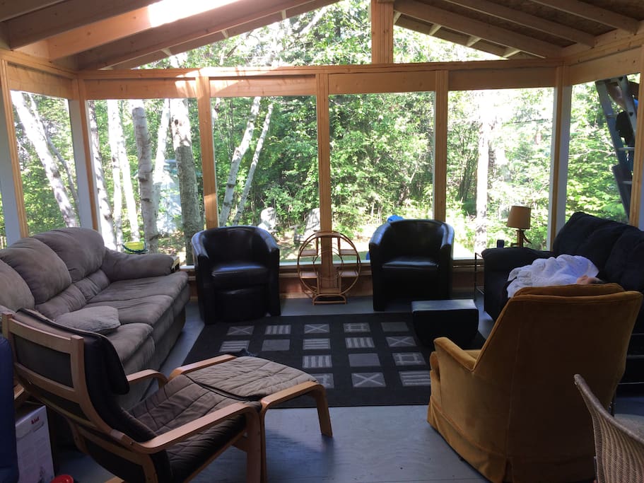 Large screened in veranda, complete with skylights, facing the backyard.