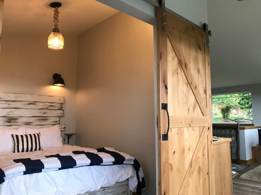 Master suite, barn doors open to full bay/Spit views